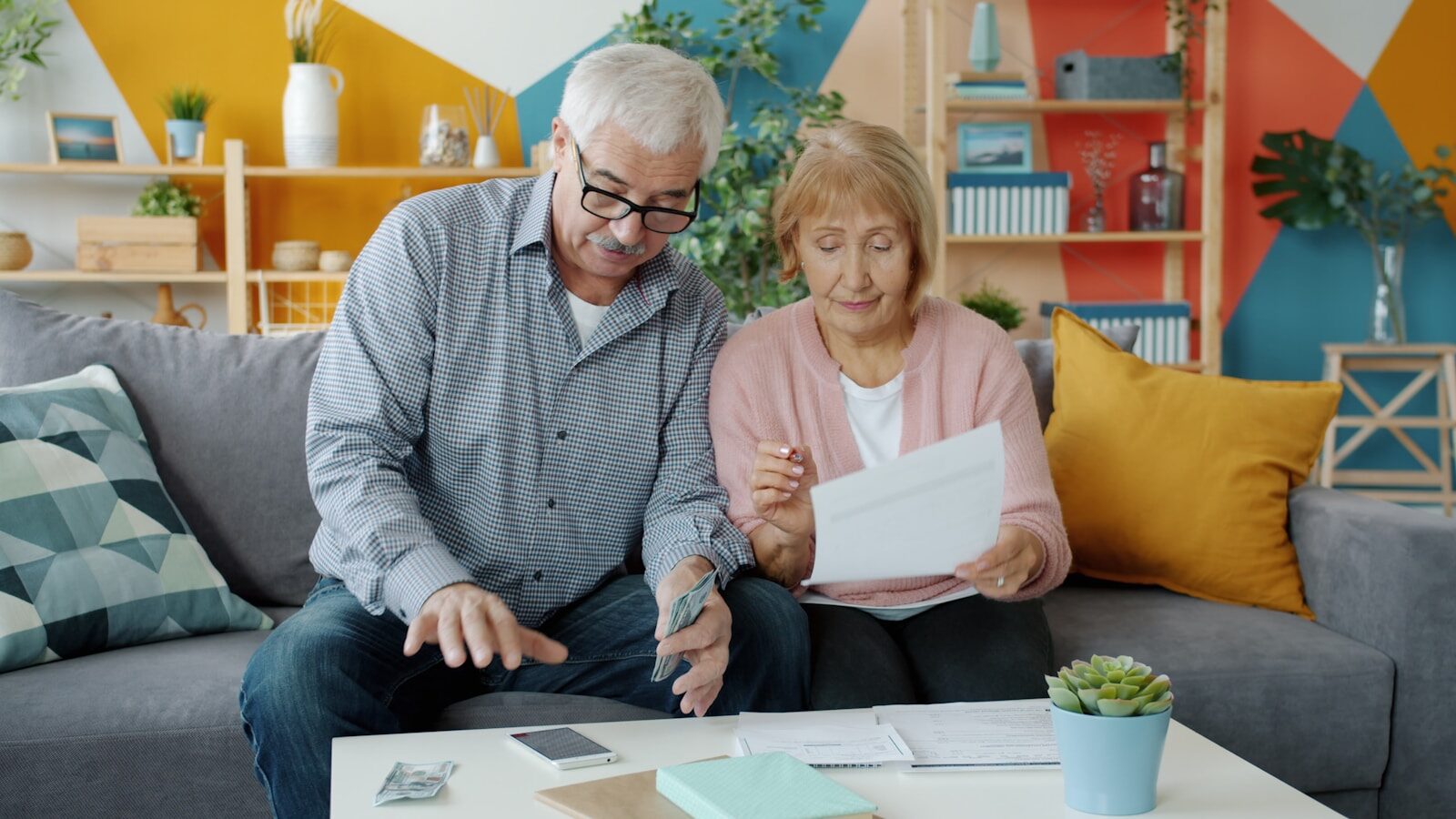Couple reviewing annuity paperwork at their kitchen table